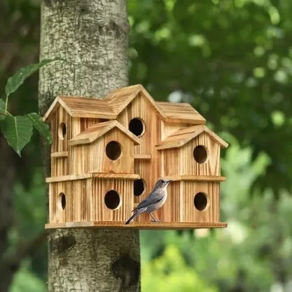Large wooden birdhouse for outside mounted on a tree trunk with a small bird at one of the entrance holes