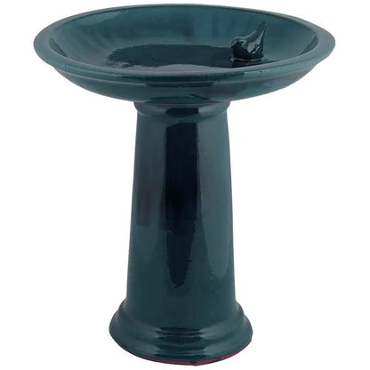 Teal ceramic bird bath on a white background