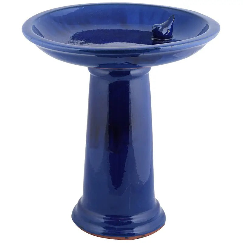 Blue ceramic bird bath on a white background