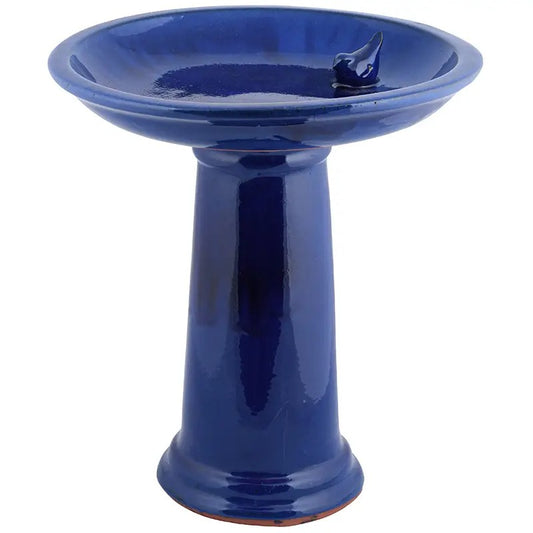 Blue ceramic bird bath on a white background